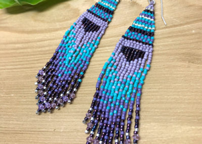B and E Fave Fringe Ombre Woven earrings on wood background.