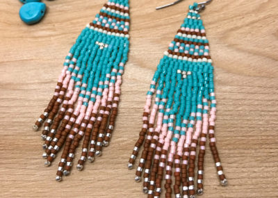 Southwestern Fringe Woven Ombre earrings on wood background.