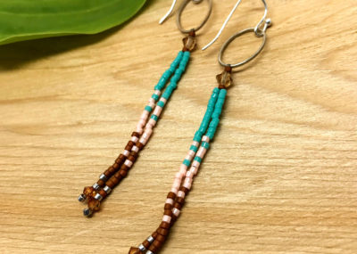 Southwestern Fringe Ombre Drop earrings on wood background.