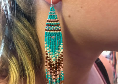 Southwestern Fringe Woven Ombre earrings on model.