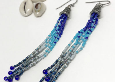 Wave of Blue Fringe Ombre Tassel earrings on white background.