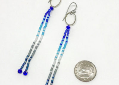 Wave of Blue Fringe Ombre Drop earrings sizing with dime.